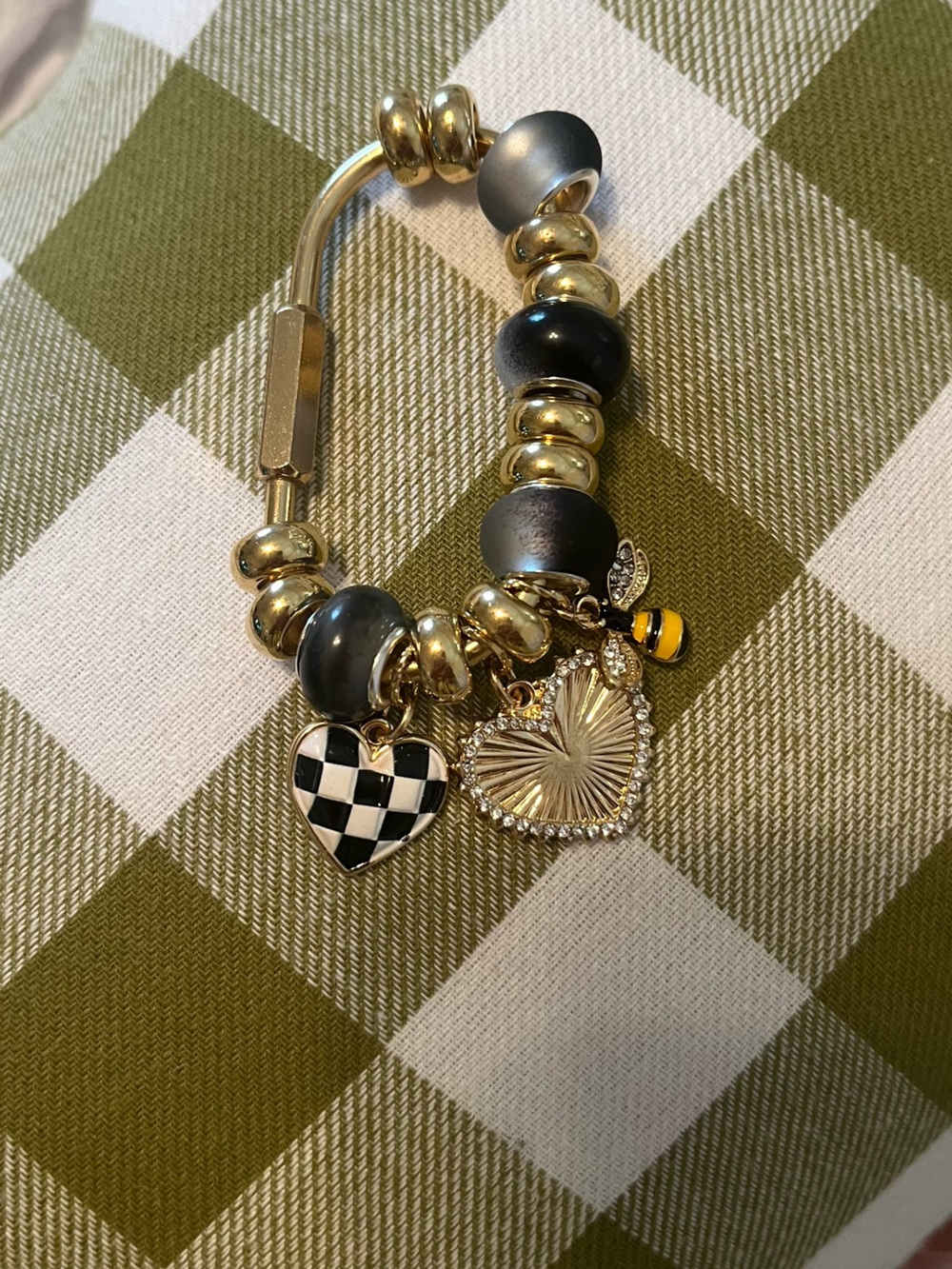 Caribina Gold Tone Charm with Black Beads and Heart Charms.